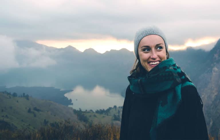 woman smiling on a mountain top