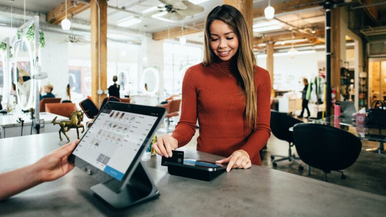 woman scanning credit card in retail shop