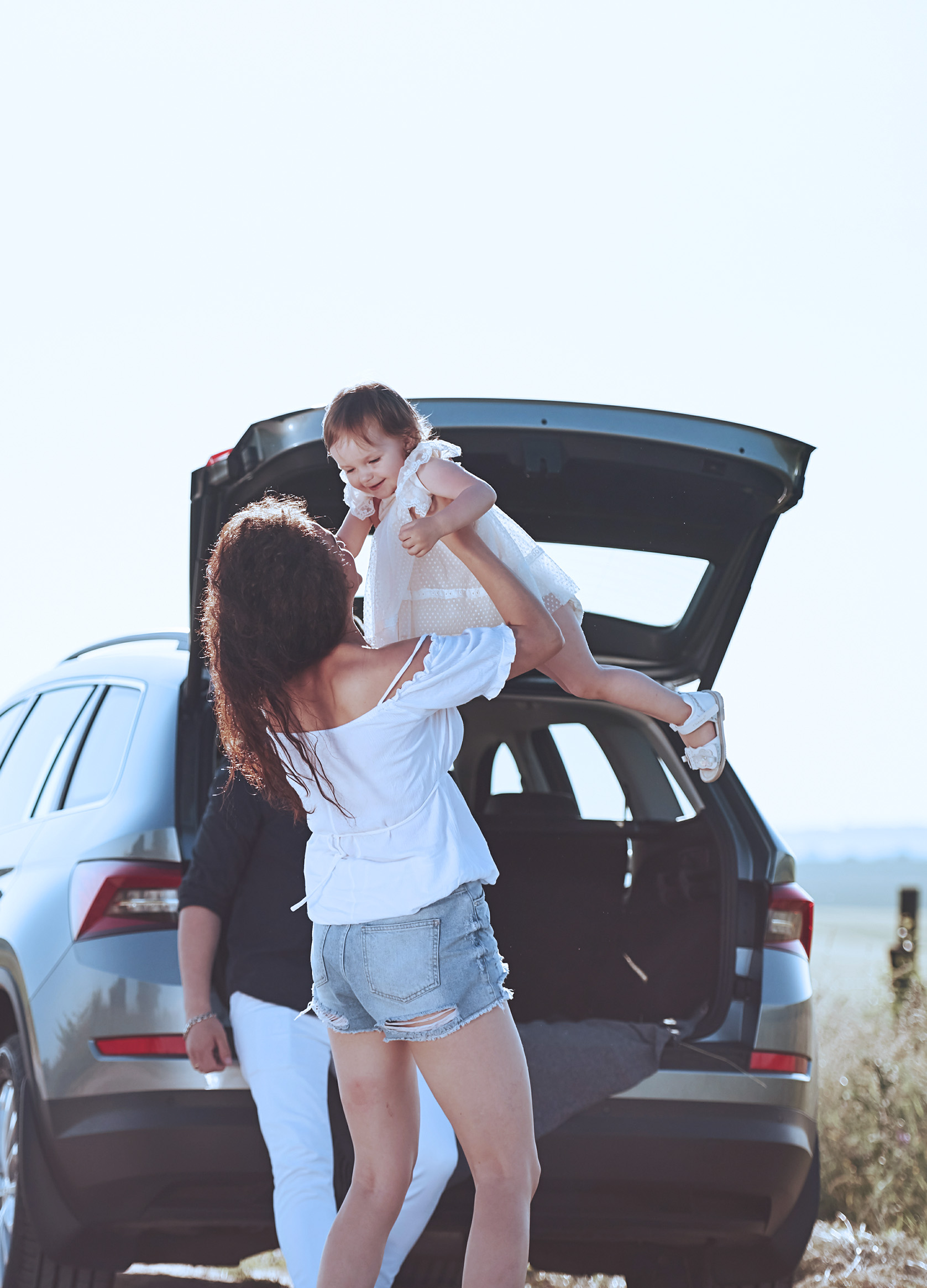 Family on the side of the road having fun.