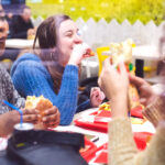 Group of girlfriends having a meal in a fast food restaurant.